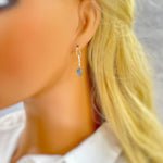 Dainty Handmade Labradorite earrings in Sterling Silver tiny gemstone dangle earrings in model's ear for scale