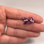 Crescent Moon Amethyst Stud Earrings in Sterling Silver in hand for scale