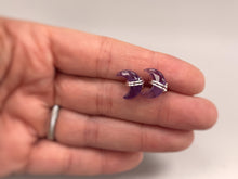 Load image into Gallery viewer, Crescent Moon Amethyst Stud Earrings in Sterling Silver in hand for scale