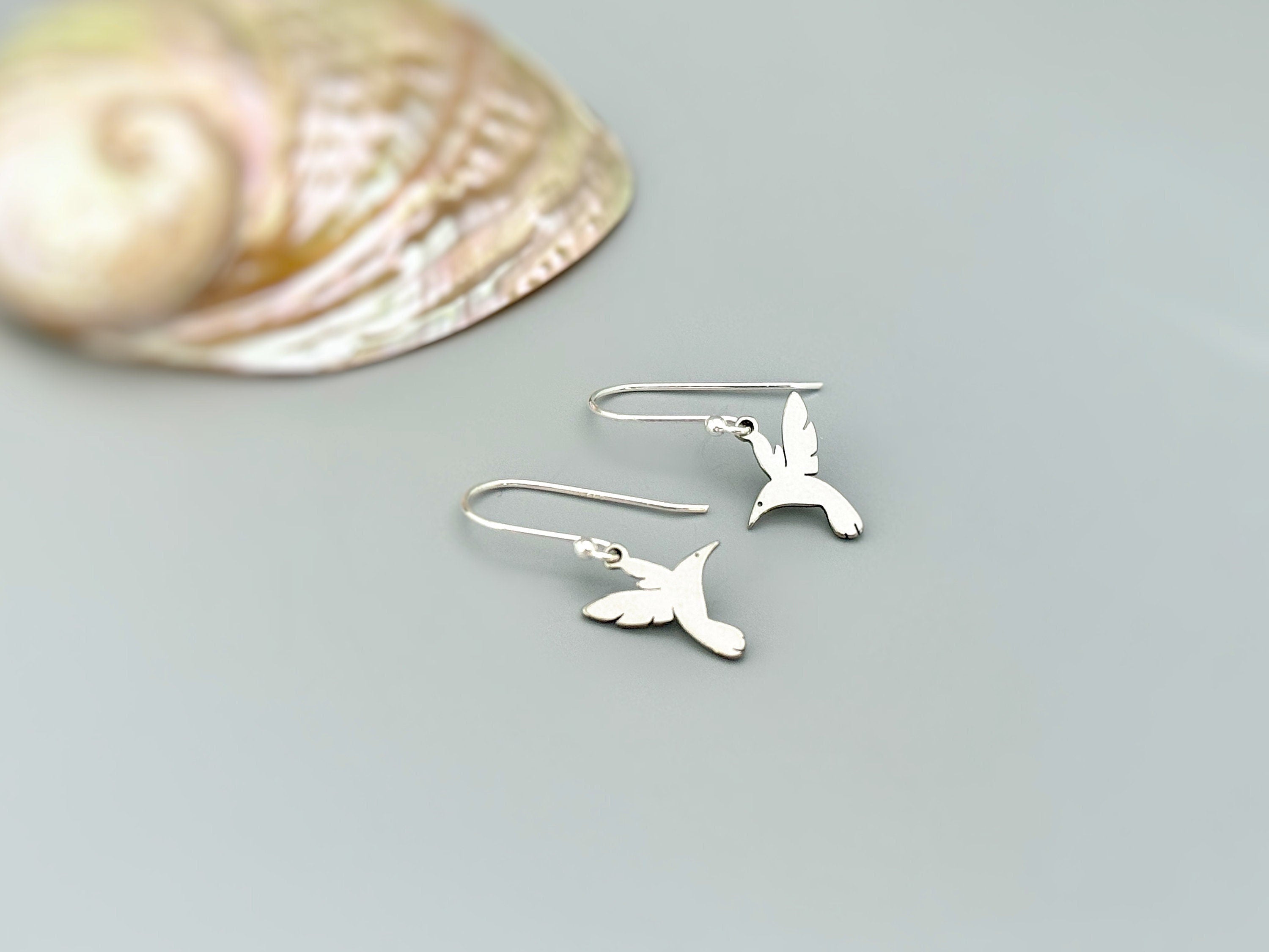 Handmade Hummingbird earrings dangle in silver of gold. These bird earrings are the perfect gift for moms, nature and bird lovers.