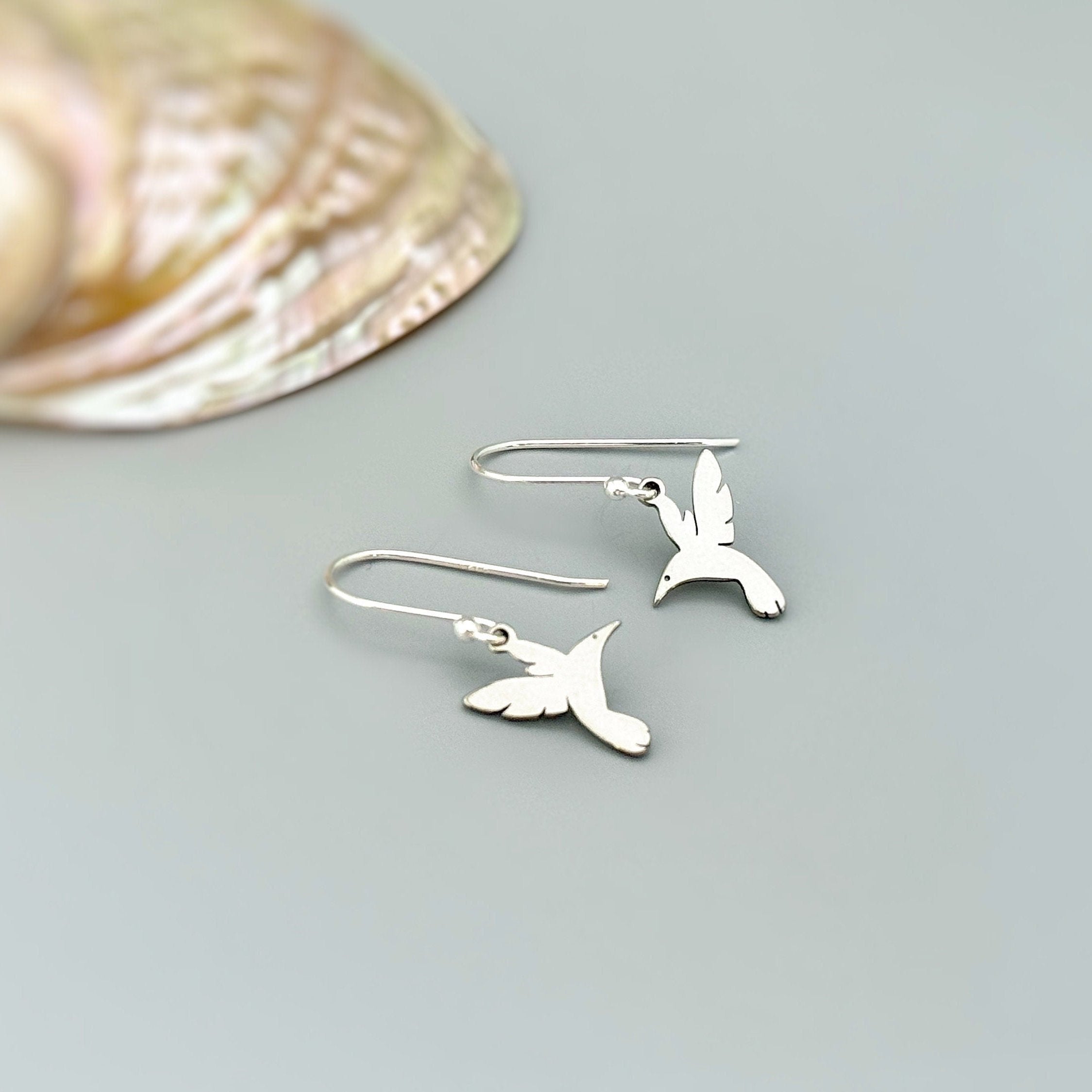 Handmade Hummingbird earrings dangle in silver of gold. These bird earrings are the perfect gift for moms, nature and bird lovers.