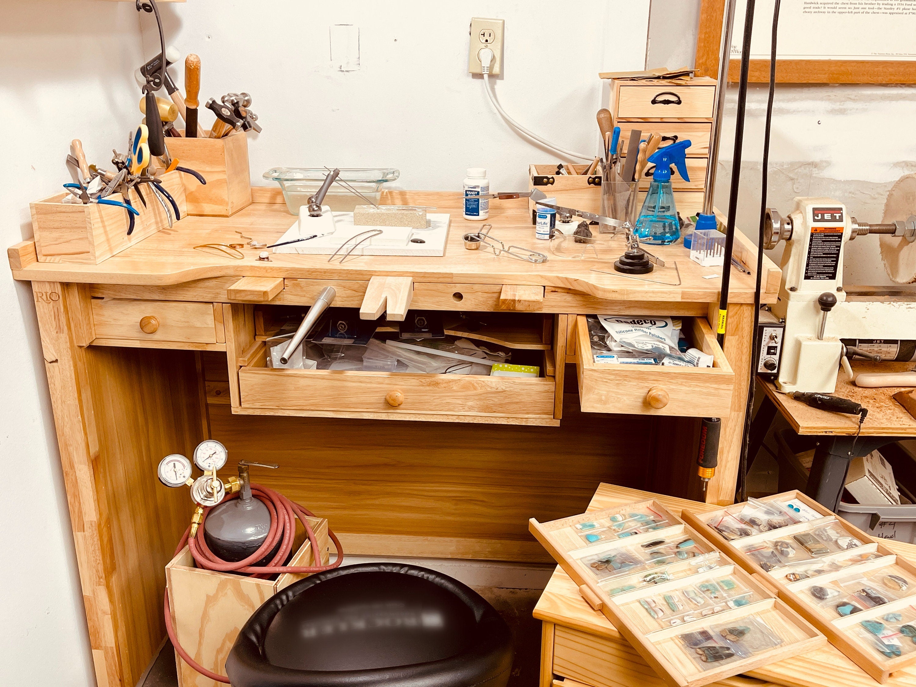 Artisan jewelry workbench with crafting tools and materials