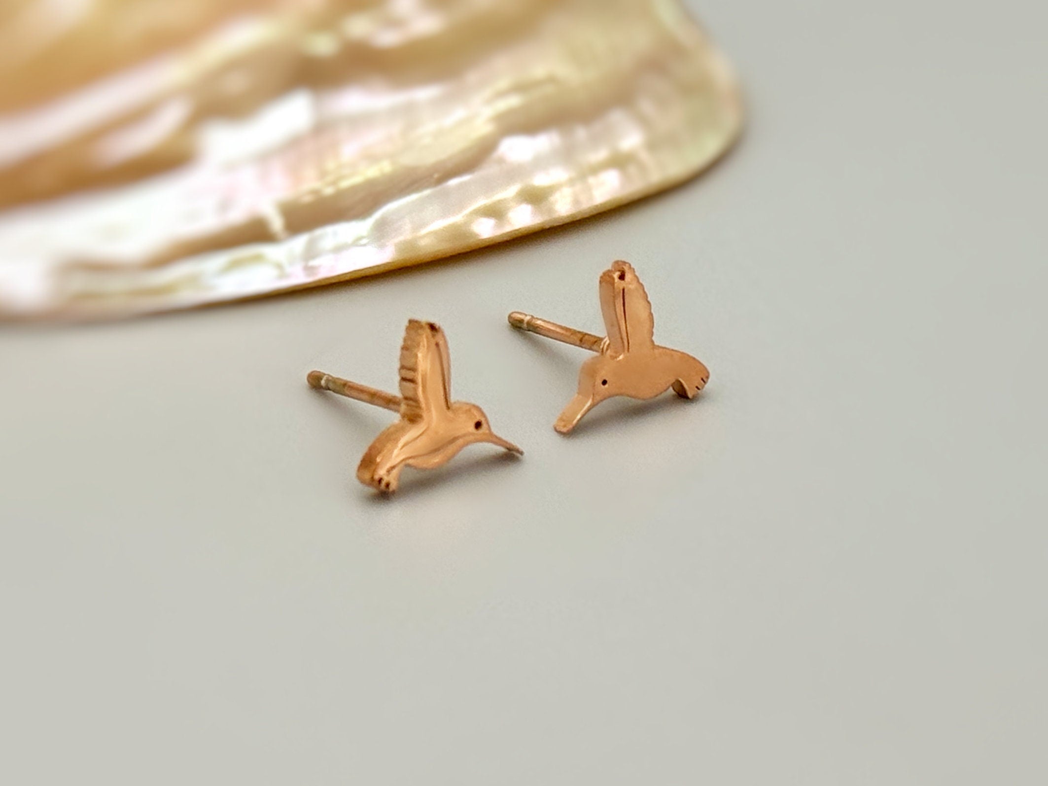 Tiny Hummingbird Earrings in rose gold, gold, and silver. Dainty second hold or cartilage earrings make a great gift for bird lovers, granddaughters, teenagers, and children.