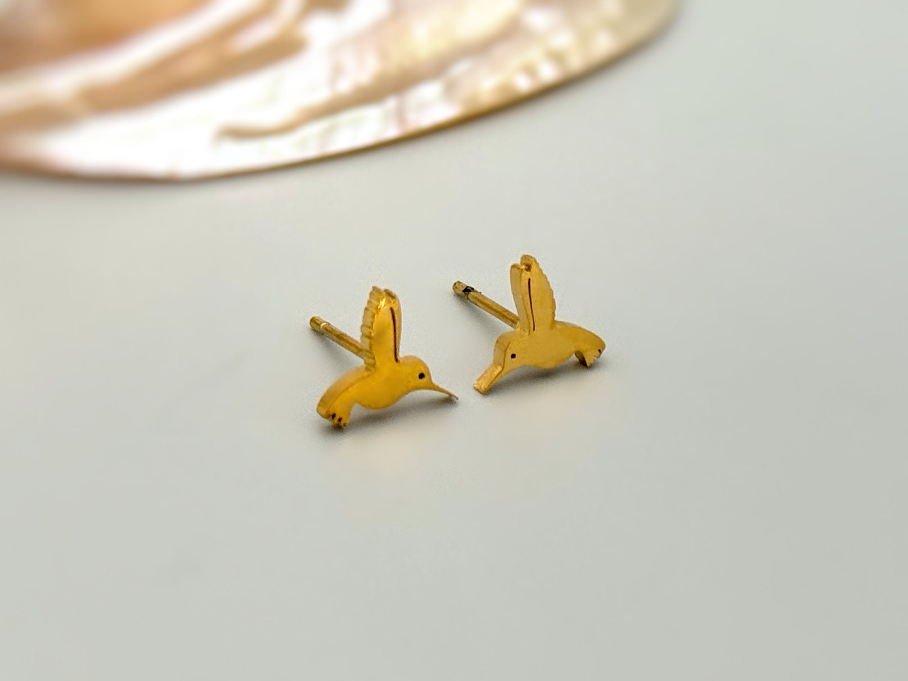 Tiny Hummingbird Earrings in gold, rose gold, and silver. Dainty second hold or cartilage earrings make a great gift for bird lovers, granddaughters, teenagers, and children.