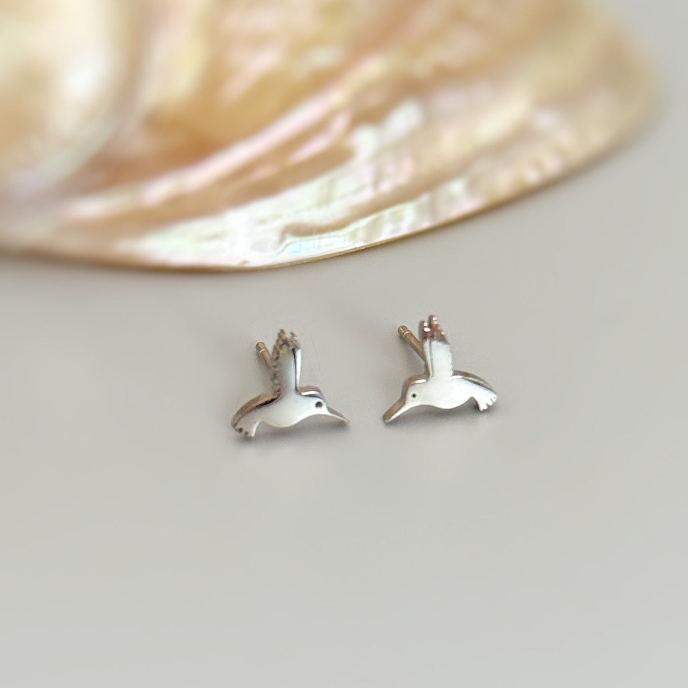 Tiny Hummingbird Earrings in silver, gold and rose gold. Dainty second hold or cartilage earrings make a great gift for bird lovers, granddaughters, teenagers, and children.