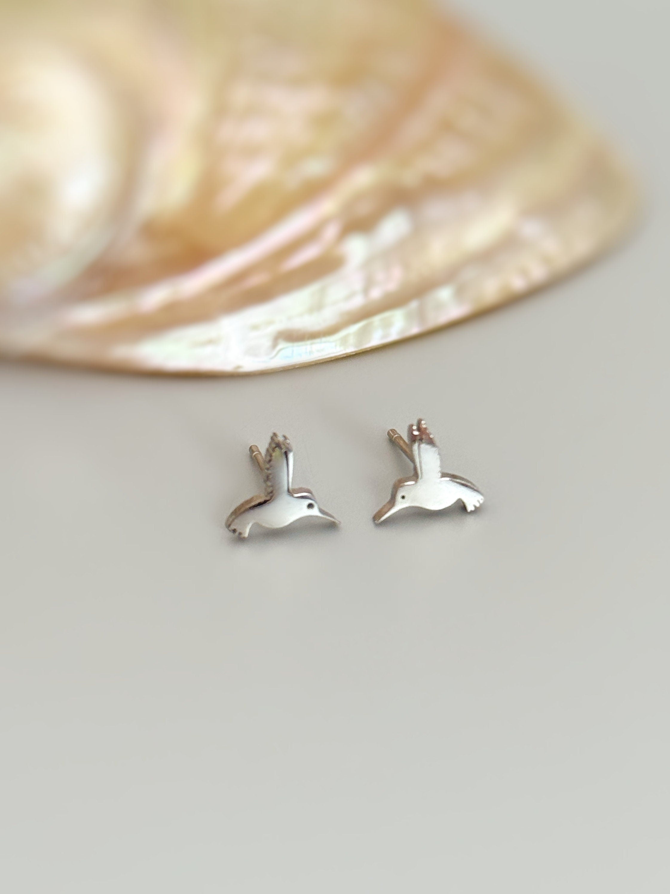 Tiny Hummingbird Earrings in silver, gold and rose gold. Dainty second hold or cartilage earrings make a great gift for bird lovers, granddaughters, teenagers, and children.