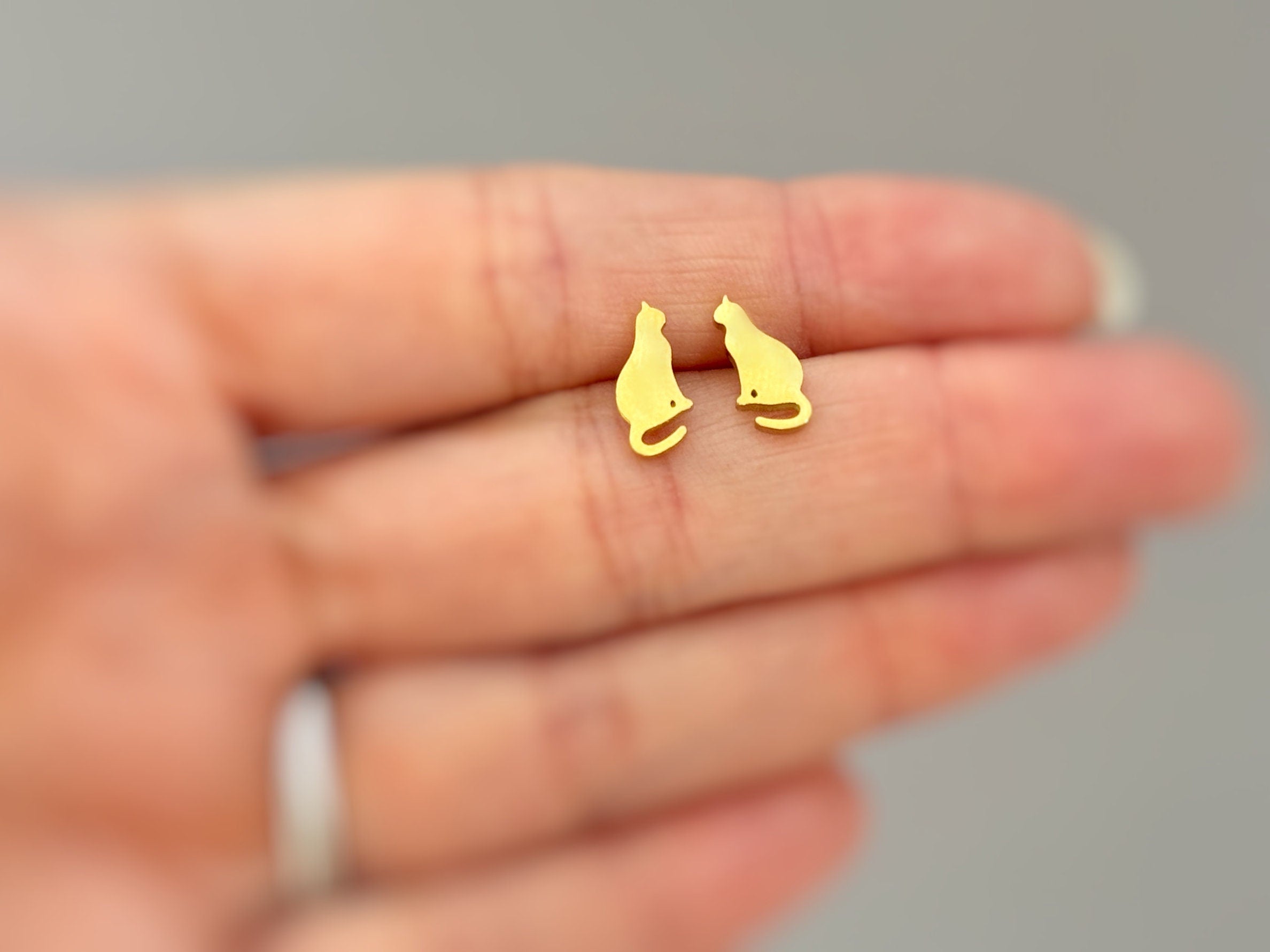 Tiny Cat Stud Earrings in gold, or silver. Dainty second hole cartilage earrings make a great gift for cat and animal lovers, moms, sisters, and friends.