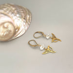 May include: A pair of gold earrings with clear crystal beads and a hummingbird design.