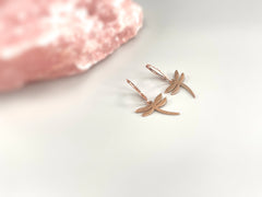 May include: Two rose gold dragonfly earrings with a hoop design