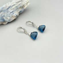 Load image into Gallery viewer, a pair of blue earrings sitting on top of a white table