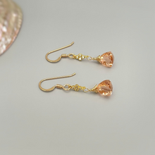 Load image into Gallery viewer, a pair of gold earrings with peach colored stones
