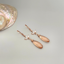 Load image into Gallery viewer, a pair of earrings sitting next to a seashell