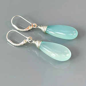 a pair of light blue glass drop earrings