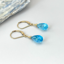 Load image into Gallery viewer, a pair of blue earrings sitting on top of a table