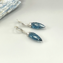Load image into Gallery viewer, a pair of blue crystal earrings sitting on top of a table