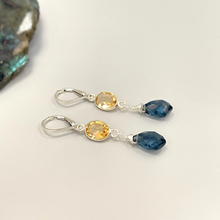 Load image into Gallery viewer, a pair of blue and yellow earrings sitting on top of a table