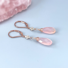 Load image into Gallery viewer, a pair of pink earrings sitting on top of a pink rock