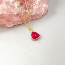 Load image into Gallery viewer, a gold necklace with a red heart on it